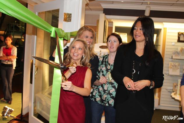 The Dandelion Patch CEO Heidi Kallett cuts the green ribbon at Thursday night's Georgetown grand opening celebration.